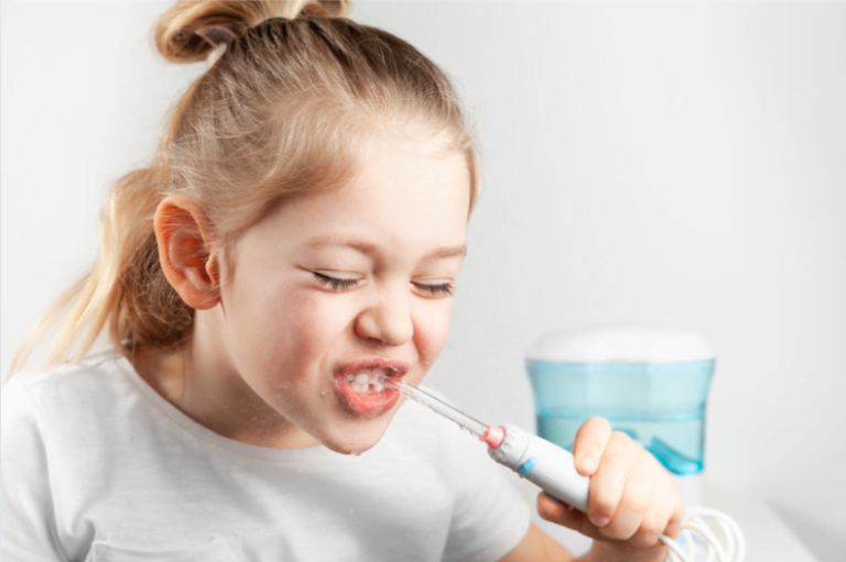 Young girl do water flossing